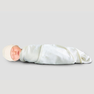 sleeping baby in cream merino swaddle wrap