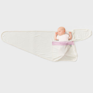 Baby asleep in pink merino swaddle wrap