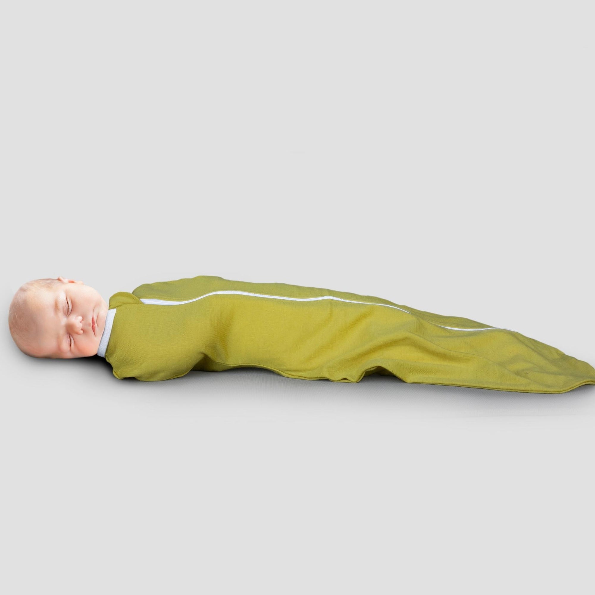 sleeping baby in yellow merino swaddle pod